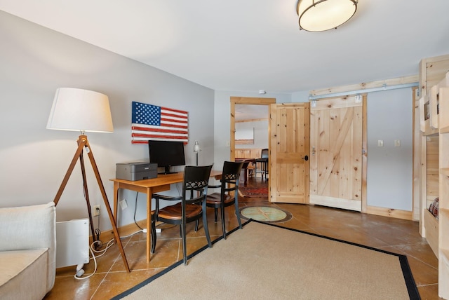 office area with a barn door and baseboards