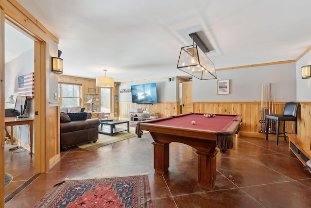 game room with a wainscoted wall, wooden walls, and pool table