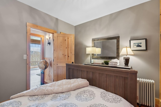 bedroom with lofted ceiling and radiator heating unit