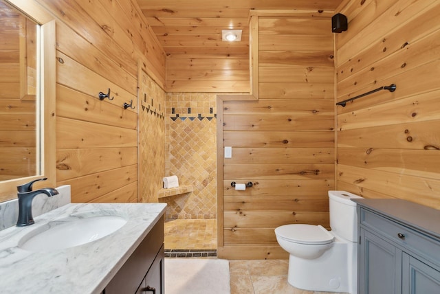 full bath with toilet, wooden walls, wood ceiling, vanity, and tile patterned floors