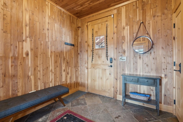 entrance foyer featuring wood ceiling, wooden walls, and stone finish floor