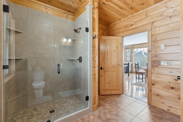 full bath with a stall shower, wood ceiling, wood walls, and tile patterned floors