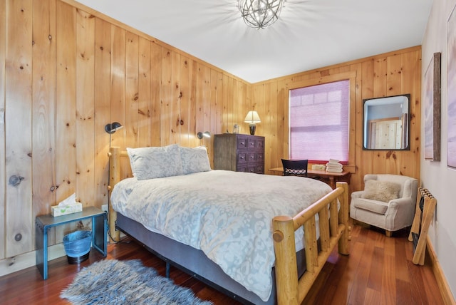 bedroom featuring wood walls and wood finished floors