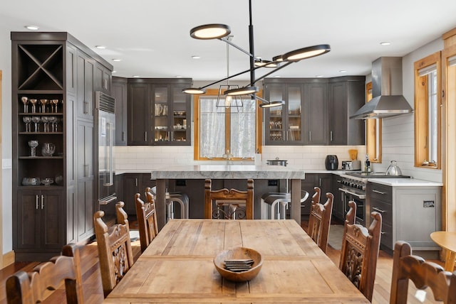 dining room with a chandelier, recessed lighting, and wood finished floors