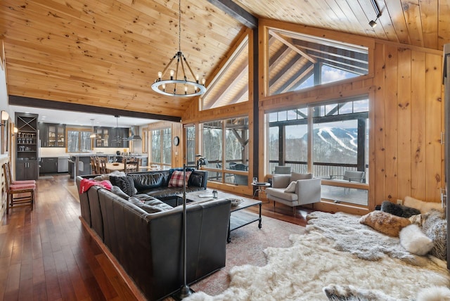 living room with a chandelier, wooden ceiling, hardwood / wood-style flooring, high vaulted ceiling, and beam ceiling