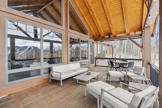 sunroom featuring wood ceiling and vaulted ceiling with beams