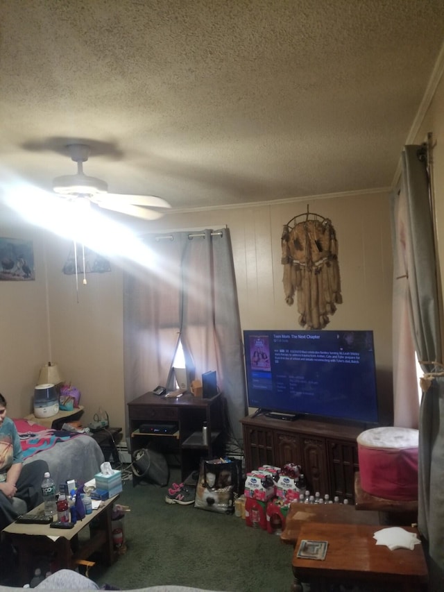 carpeted living area featuring a ceiling fan, a textured ceiling, and ornamental molding