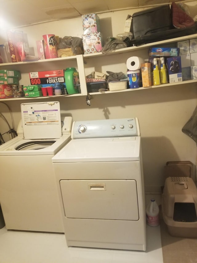 clothes washing area with laundry area and washer and clothes dryer