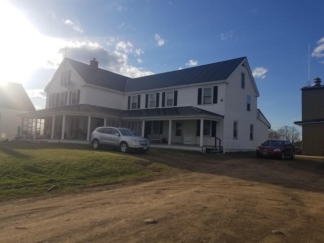 6 Exchange St, Ashland, ME 04732 - exterior space with a lawn, covered porch, a chimney, and metal roof