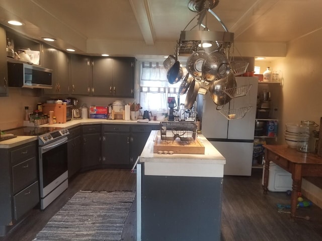 46 Collins St, Caribou, ME 04736 - kitchen with dark wood-style floors, stainless steel appliances, a kitchen island, and beam ceiling