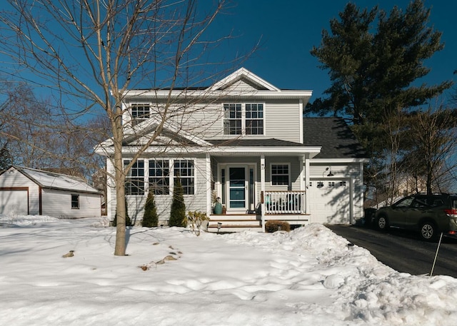 traditional-style home featuring a porch, driveway, and an attached garage