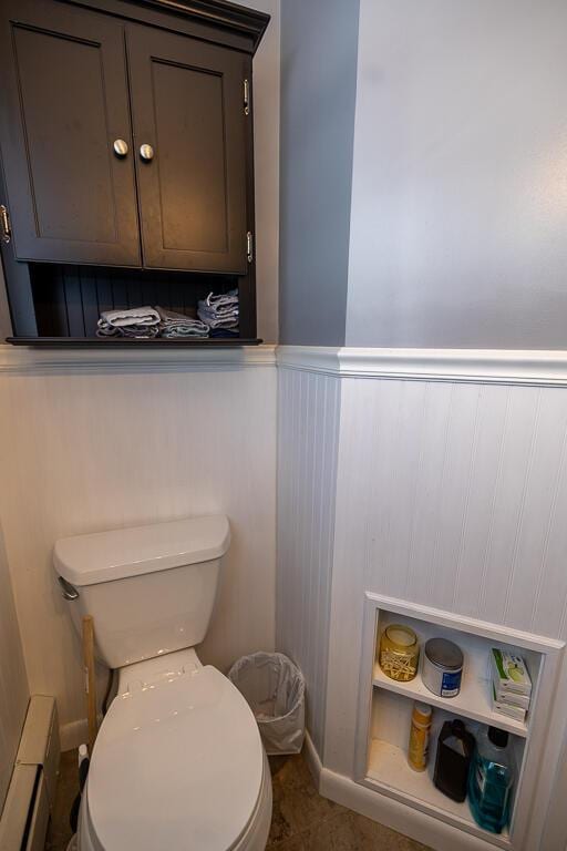 bathroom featuring toilet and wainscoting