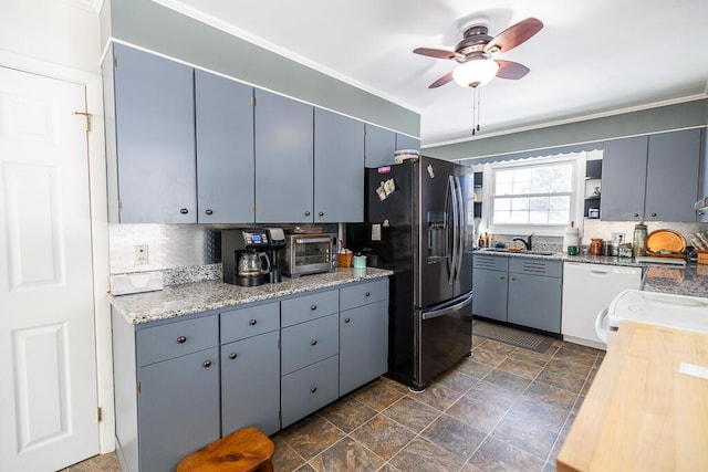 kitchen featuring a toaster, tasteful backsplash, ceiling fan, white dishwasher, and refrigerator with ice dispenser