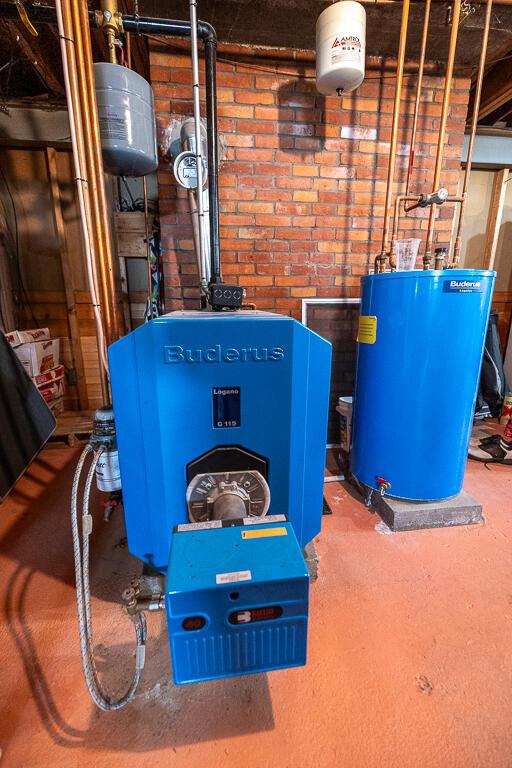 utility room featuring water heater