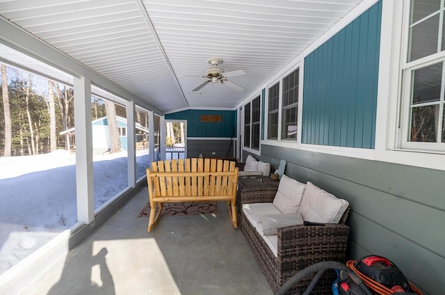 sunroom featuring a ceiling fan and vaulted ceiling