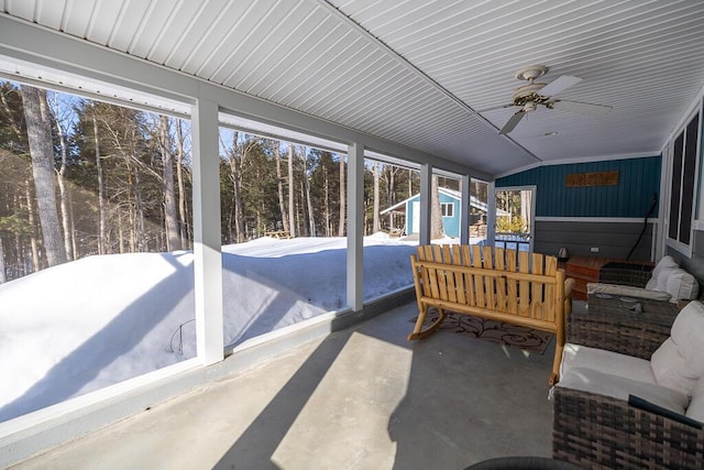 sunroom / solarium with lofted ceiling and ceiling fan