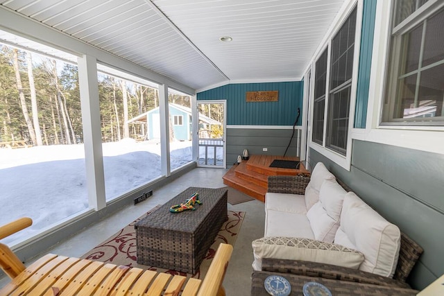 sunroom featuring vaulted ceiling