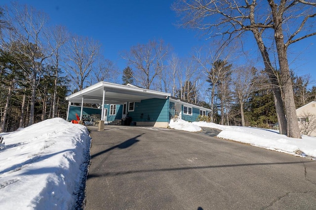 view of front of property with a carport and aphalt driveway