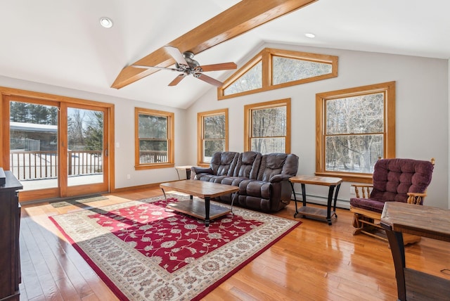 living area featuring lofted ceiling with beams, baseboard heating, light wood-style flooring, and baseboards