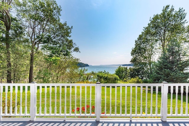 exterior space featuring a water view and a lawn