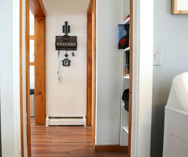 hallway featuring baseboard heating and wood finished floors