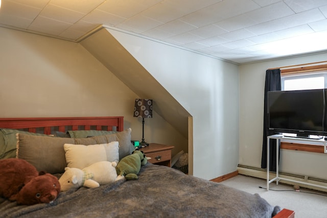 carpeted bedroom with a baseboard heating unit and baseboards