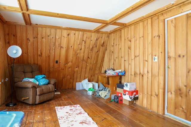 interior space with coffered ceiling, beamed ceiling, wooden walls, and hardwood / wood-style floors