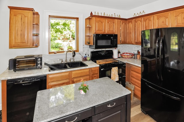 kitchen featuring tasteful backsplash, a toaster, black appliances, open shelves, and a sink