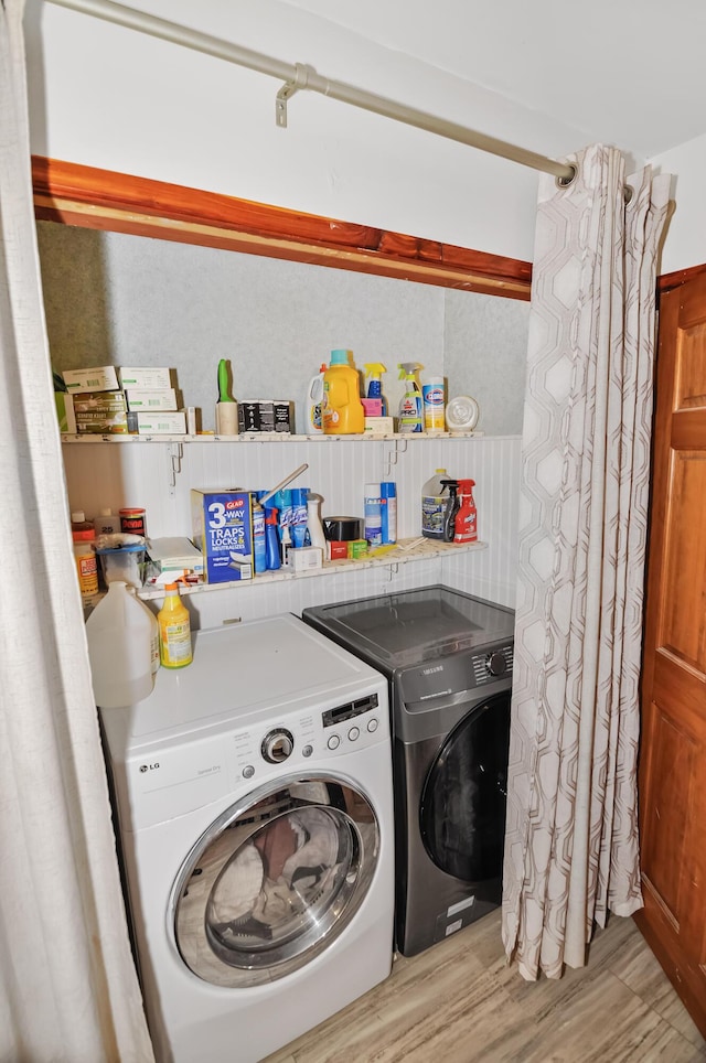 laundry room with washer and dryer, laundry area, and light wood-style flooring