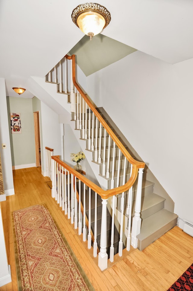 stairs with wood-type flooring and baseboards