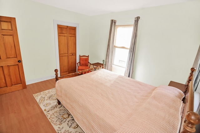 bedroom featuring light wood-style flooring and baseboards