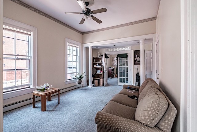 carpeted living area featuring ceiling fan, a wealth of natural light, ornate columns, and ornamental molding