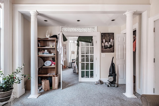 interior space with decorative columns and carpet floors