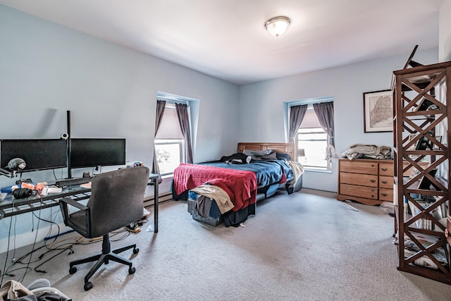 bedroom with carpet floors and a baseboard radiator