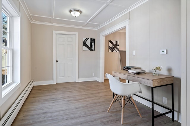 home office with light wood-type flooring, a baseboard heating unit, baseboards, and ornamental molding