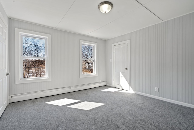 carpeted spare room featuring a baseboard radiator and baseboards