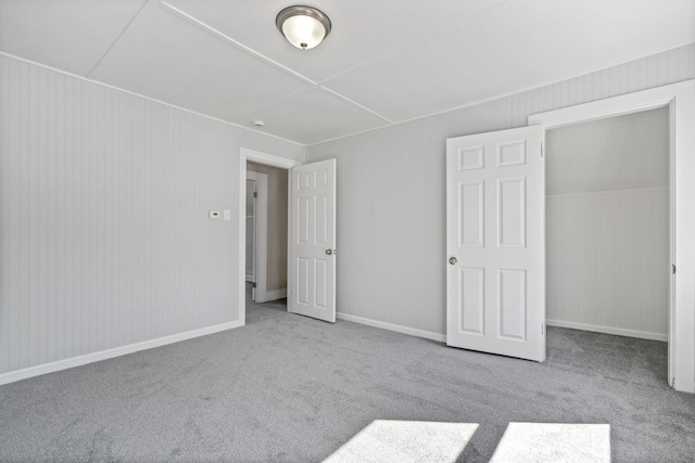 unfurnished bedroom with carpet flooring and baseboards