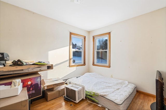 bedroom featuring baseboards and hardwood / wood-style floors