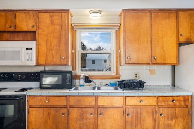 kitchen featuring brown cabinets, white appliances, backsplash, and a sink