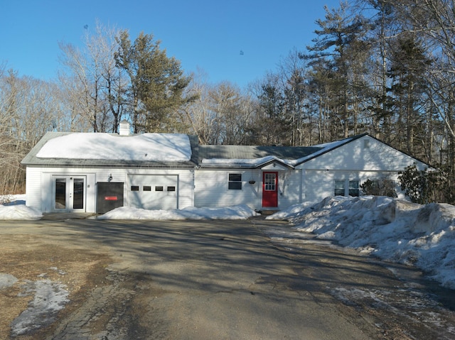 view of front facade featuring french doors and an attached garage