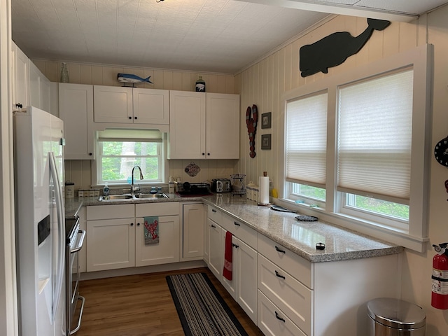 kitchen with fridge with ice dispenser, stainless steel range with electric cooktop, wood finished floors, white cabinets, and a sink