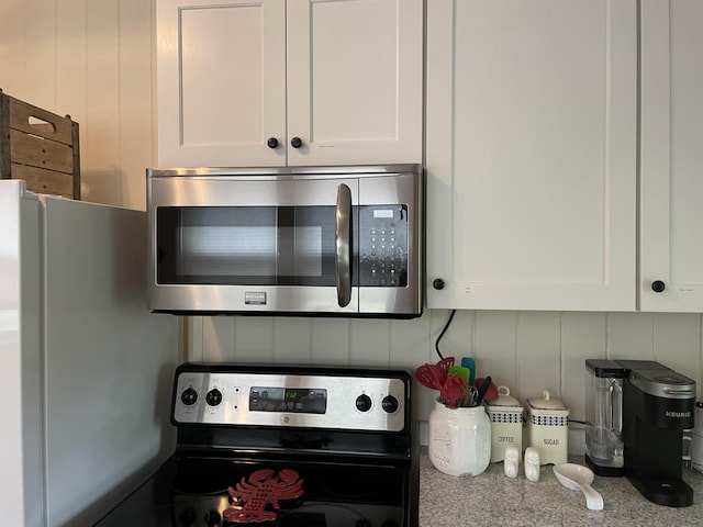 room details featuring white cabinetry and stainless steel appliances