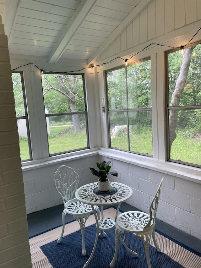 sunroom with vaulted ceiling with beams and wood ceiling