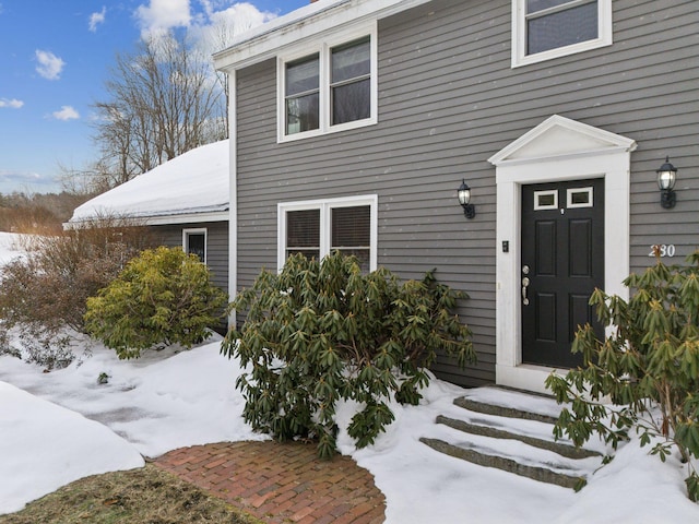 view of snow covered property entrance