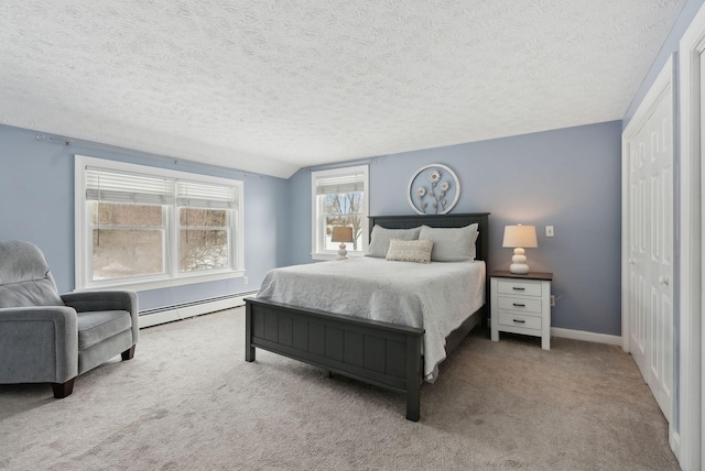 bedroom featuring a textured ceiling, a baseboard heating unit, carpet flooring, baseboards, and vaulted ceiling