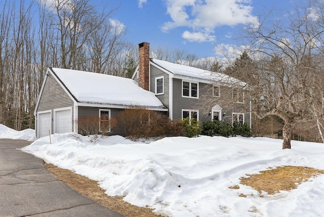 view of front of house with a garage and a chimney