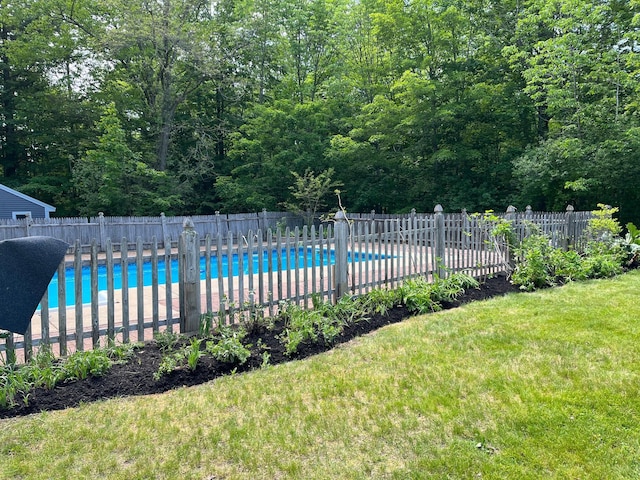 view of swimming pool with a fenced in pool, fence, and a lawn