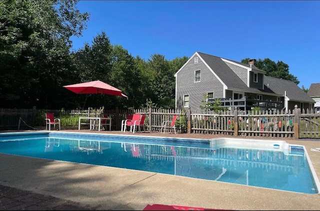 view of swimming pool with fence and a fenced in pool