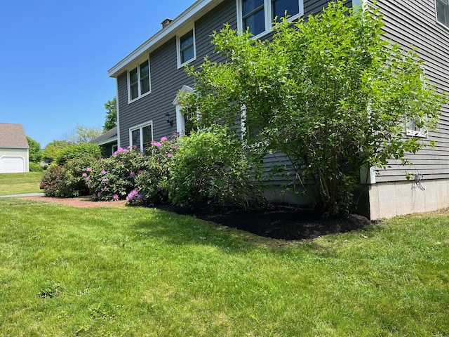 view of side of home featuring a lawn