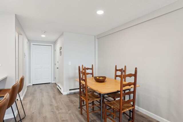 191 E Grand Ave Unit 606, Old Orchard Beach, ME 04064 - dining space with wood finished floors, a baseboard radiator, baseboards, and recessed lighting